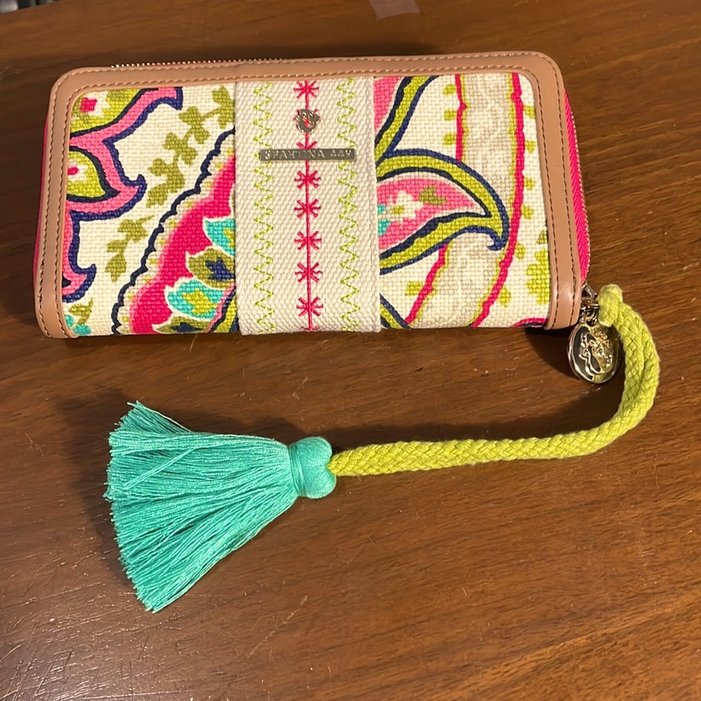 Woman’s Spartina 449 wallet with gold zipper and tassel.